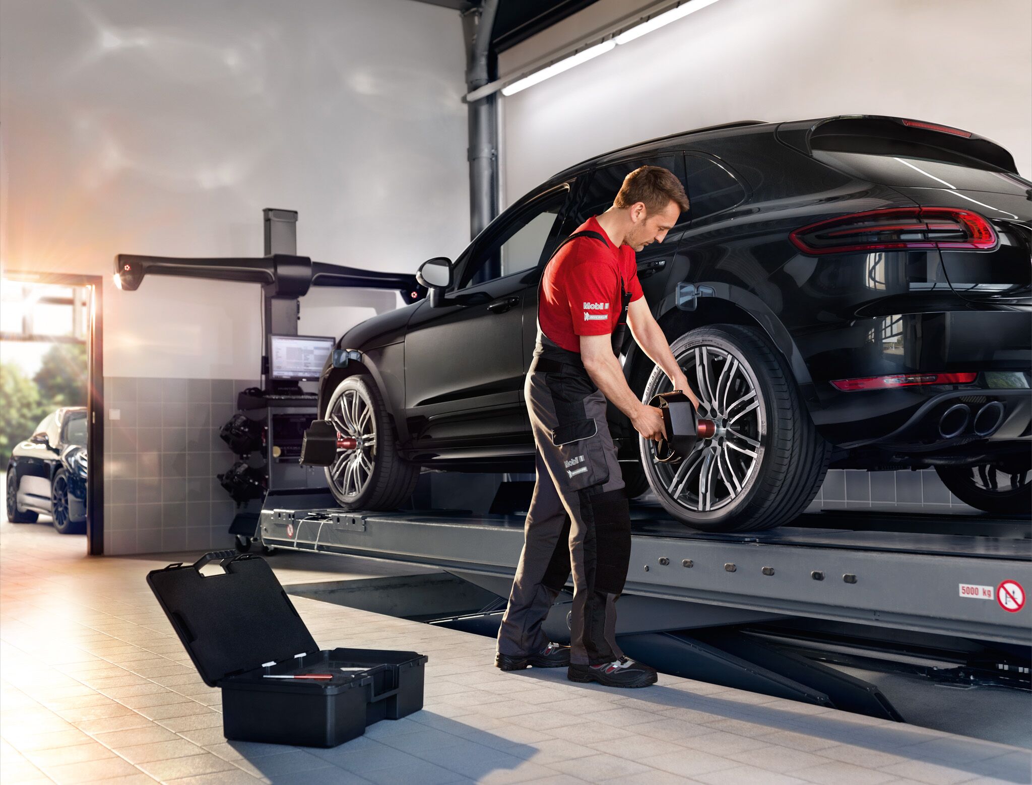 A car mechanic is working on a car's tire
