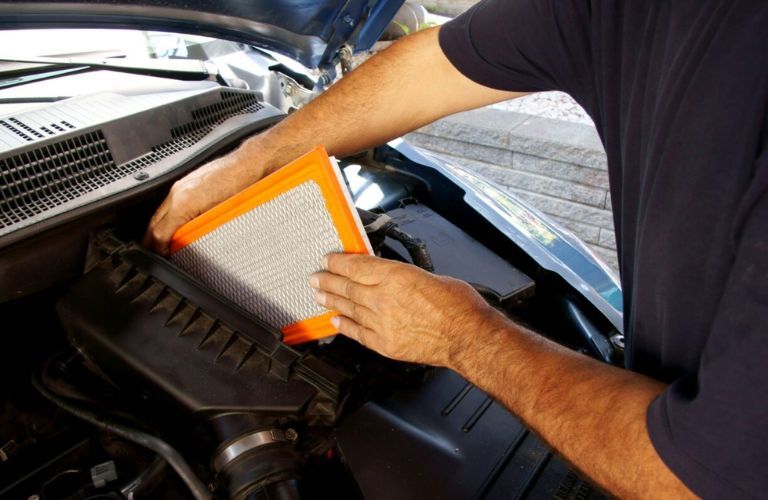 Technician undertaking air filter replacement