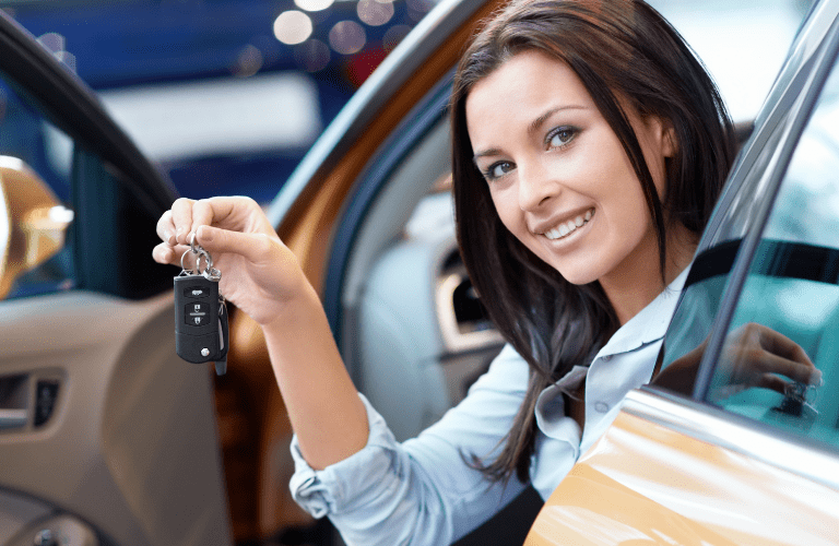 A woman showing the key