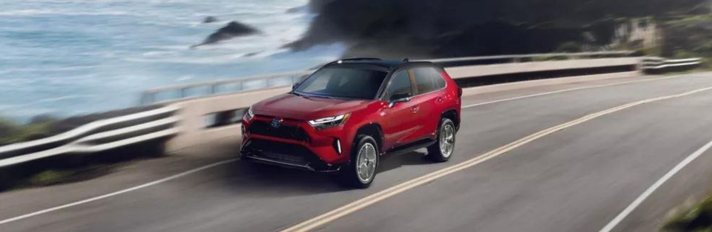 A 2023 Toyota RAV4 Prime speeding on a road
