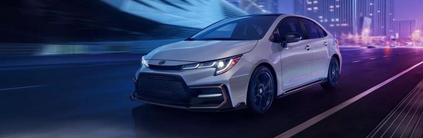 Front view of the 2022 Toyota Corolla in white driving on road
