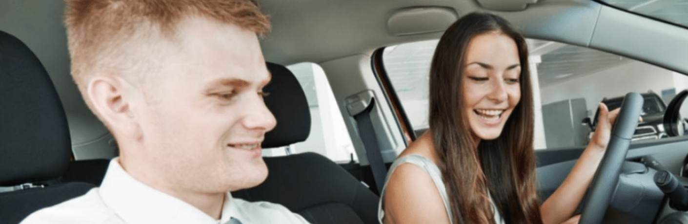Customer and salesperson having a conversation inside a vehicle
