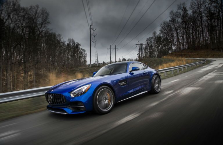 2018 MB GT Coupe exterior front fascia and driver side going fast on blurred highway bridge