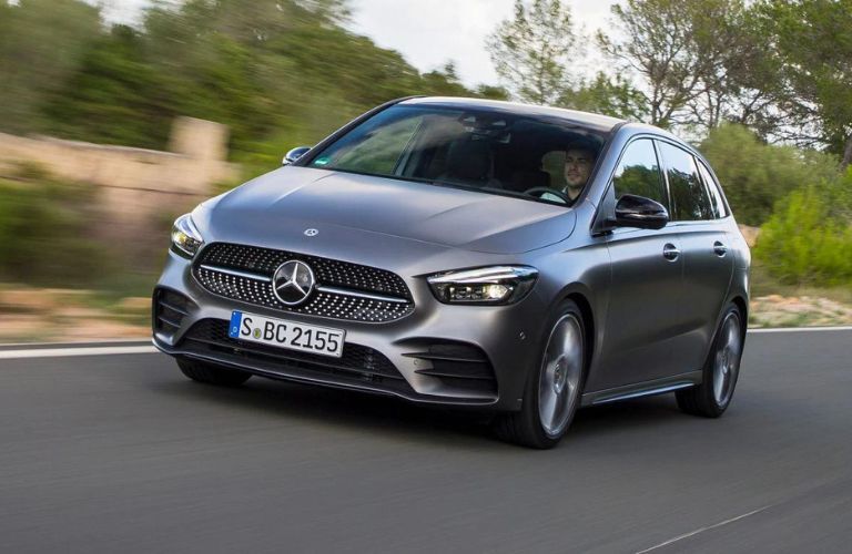 One dark color B-Class Mercedes-Benz is running on the road.