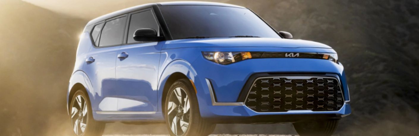 A 2023 Kia Soul backdropped by mountains
