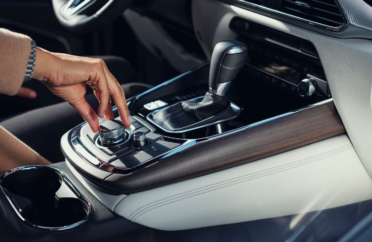 Woman adjusting the media setting in the 2021 Mazda CX-9