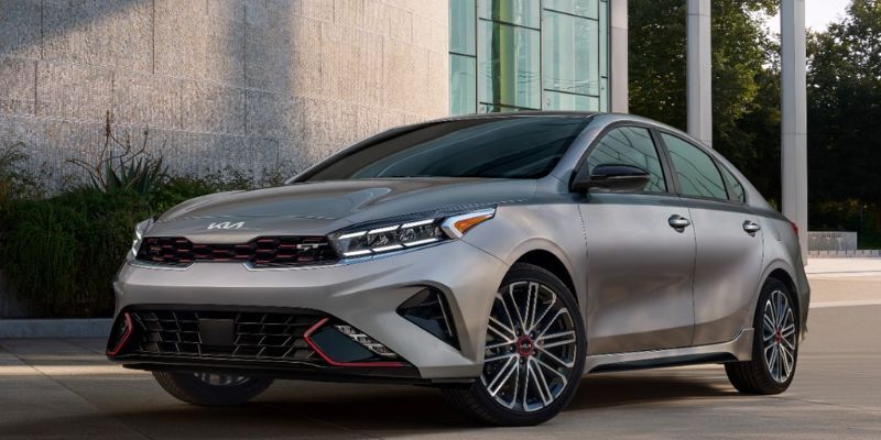 New Kia Forte parked near a house