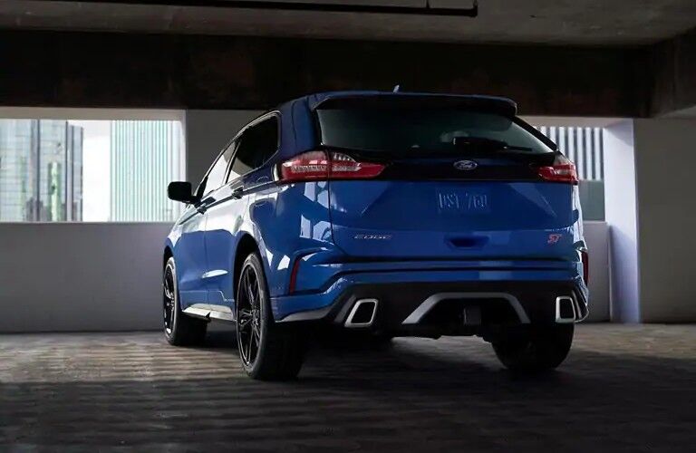 Rear view of blue 2020 Ford Edge ST parked in garage