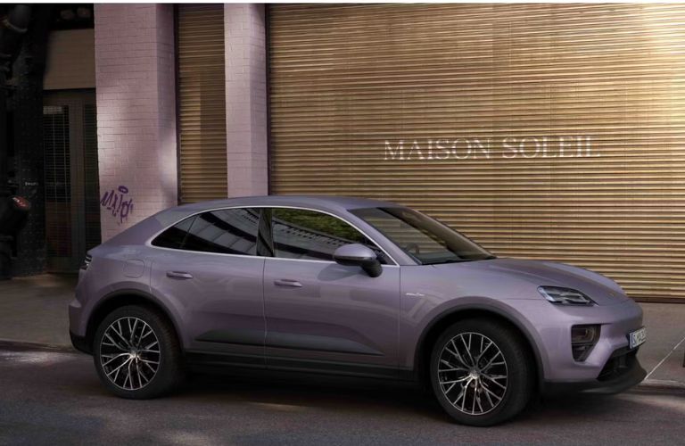 2024 Porsche Macan 4 Electric parked outside a shop
