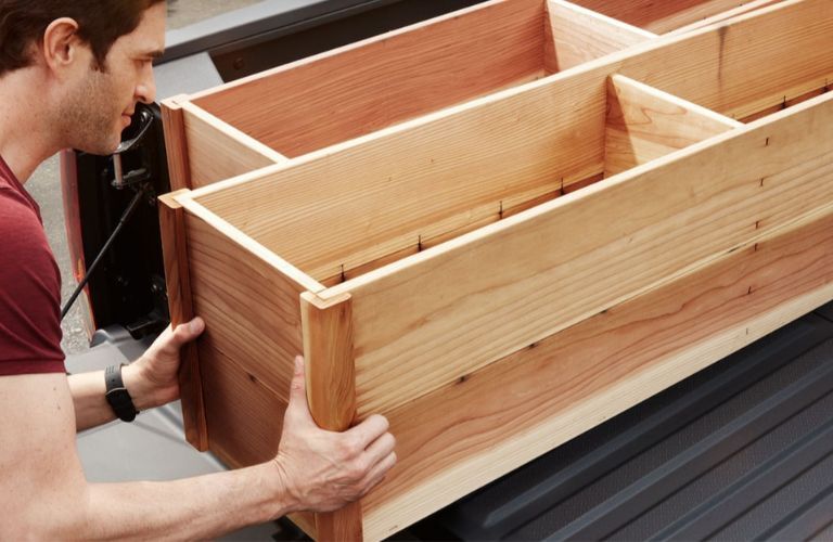 Man loading cargo onto the 2023 Honda Ridgeline