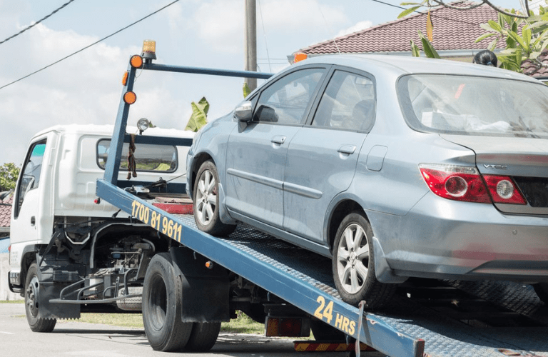 Car being towed on the road