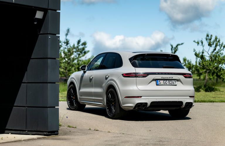white 2021 Porsche Cayenne rear fascia driver side parked on gravel driveway