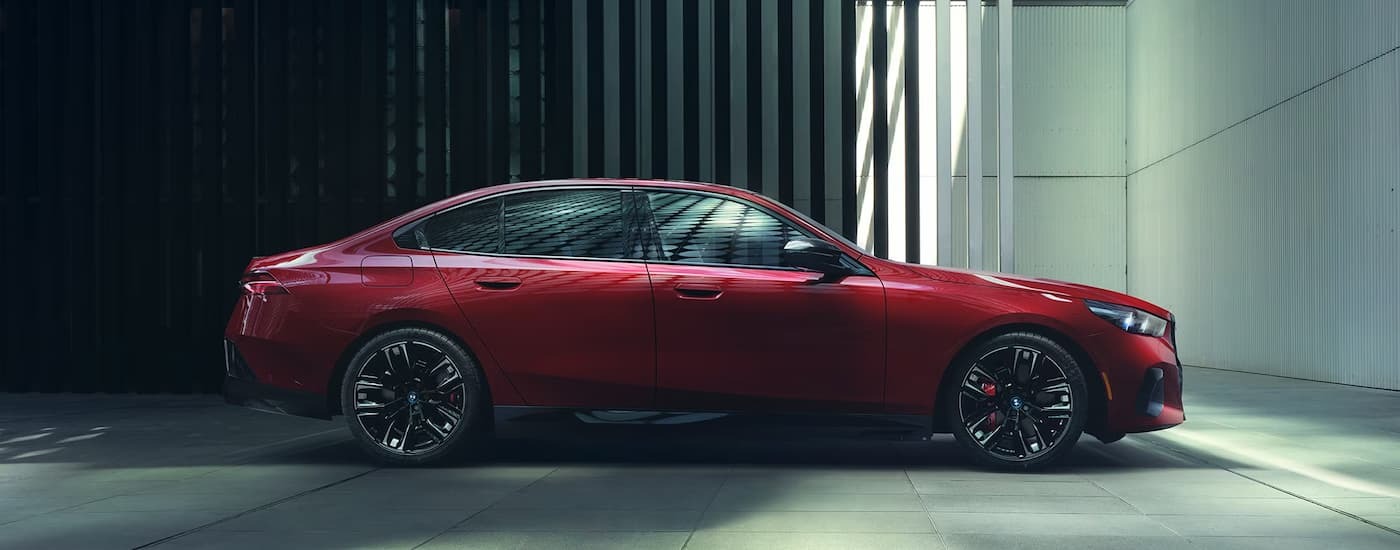 Red 2026 BMW i5 M60 parked near a driveway.