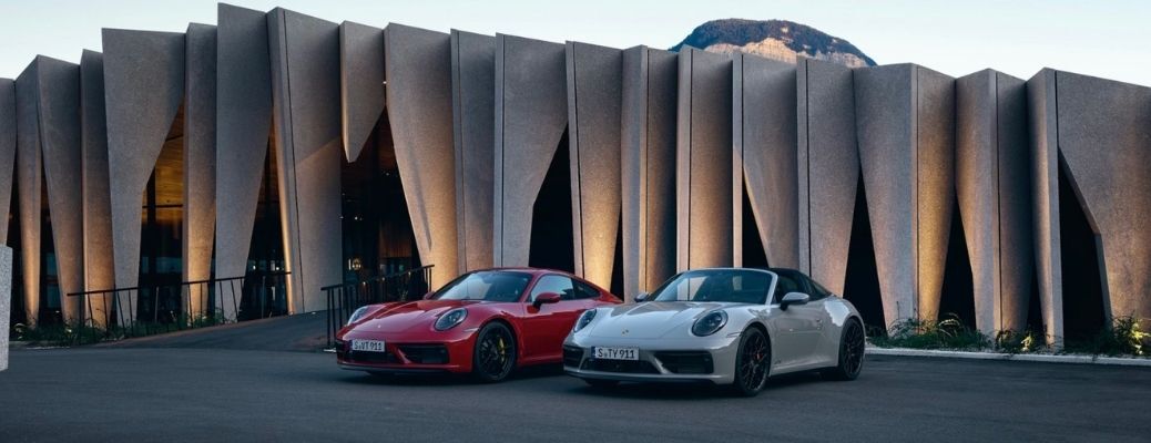 Two 2022 Porsche 911 GTS parked in front of a building