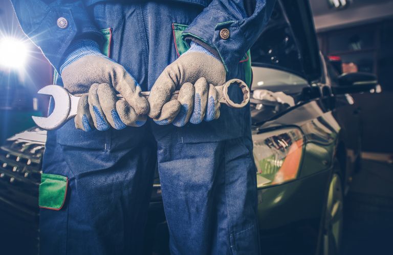 technician showing a tool with his back to the camera