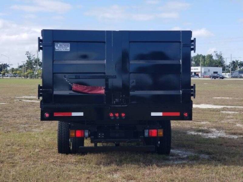 A rear exterior view of a landscaping dump truck
