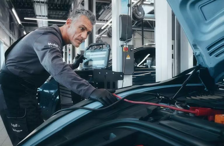 Technician servicing a Porsche