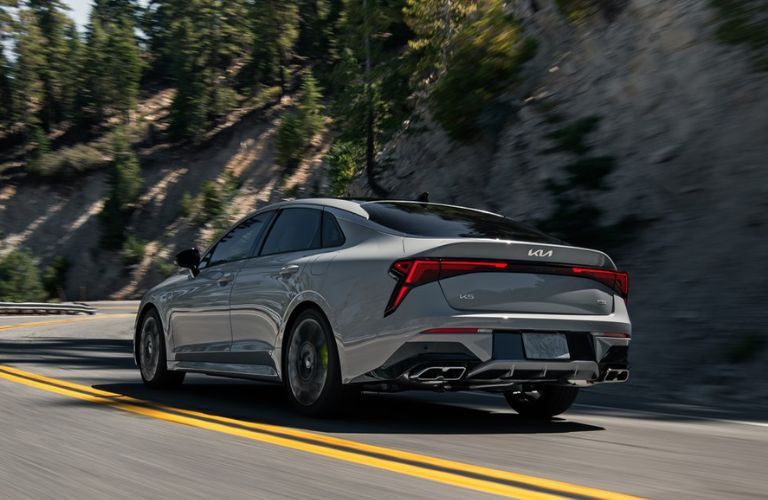 2025 Kia K5 exterior rear view while driving on the road