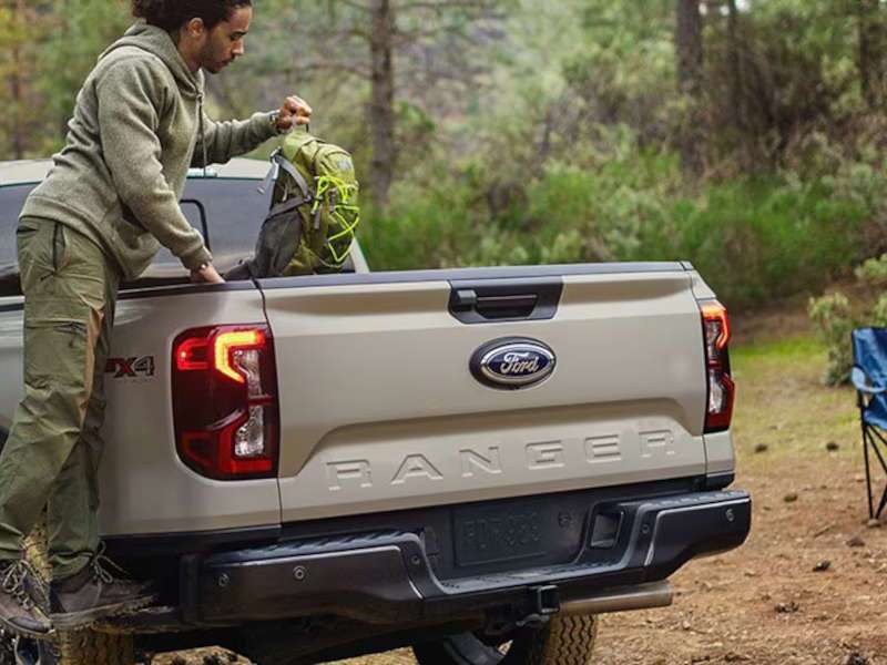 A man using the cargo bed in the 2025 Ford Ranger XL.