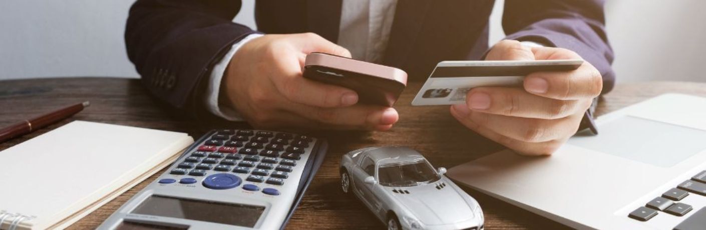 a man filling his credit card information in phone