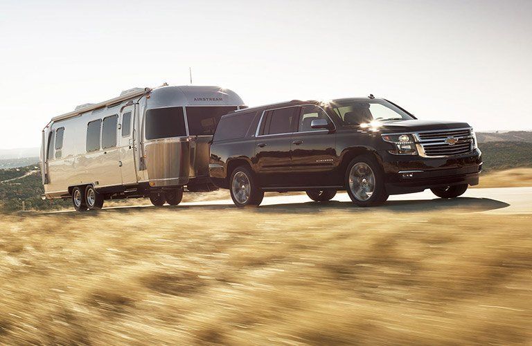 Chevy with a camper attached to it
