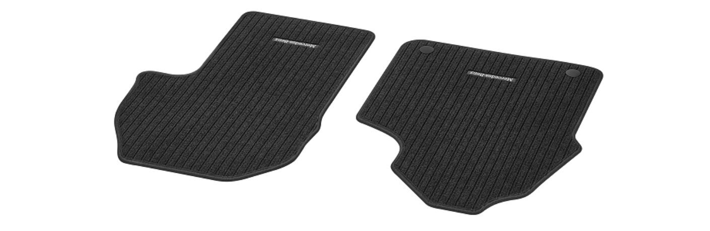 two Mercedes-Benz floor mats with a logo