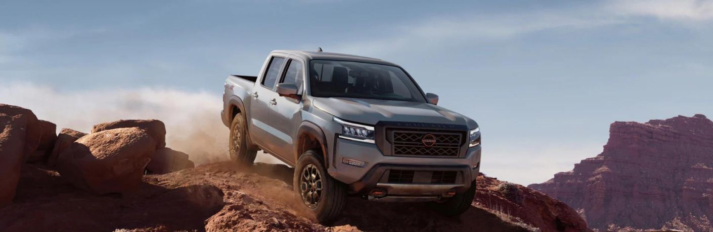 A 2023 Nissan Frontier descending a rocky hill