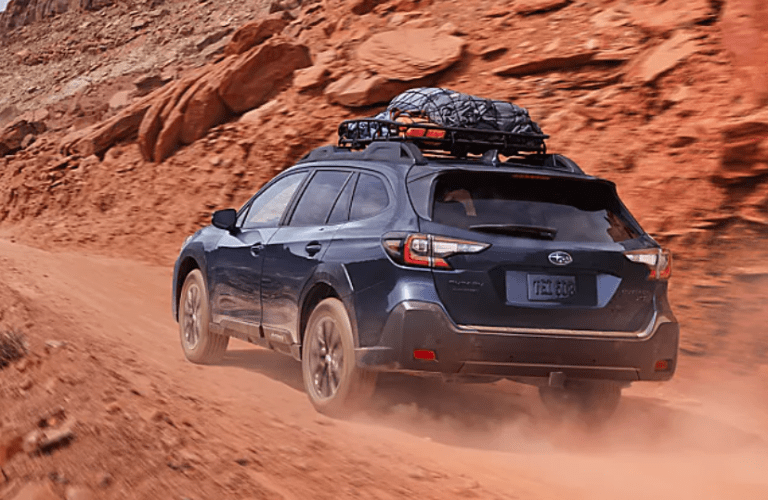 Back view of the 2025 Subaru Outback on a rough terrain