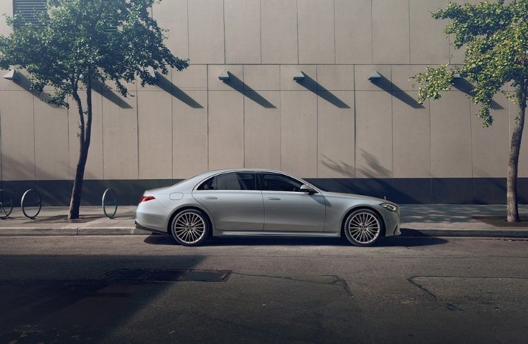 side view image of a Mercedes-Benz sedan on a road