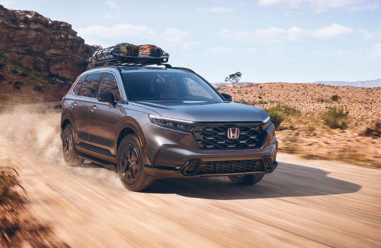2024 Honda CR-V Hybrid speeding through a dusty trail