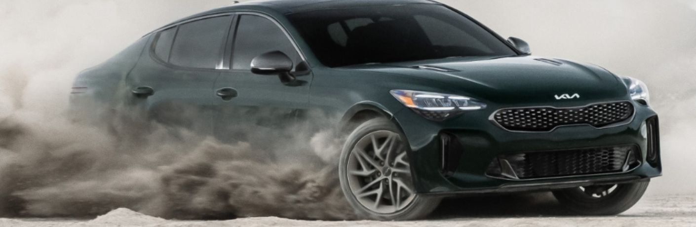 2023 Kia Stinger Green driving through dust