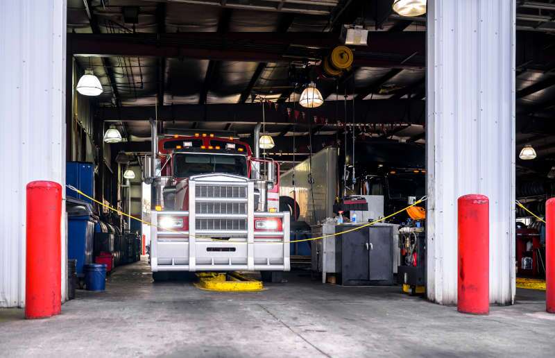 A commercial truck in the shop for an oil change.