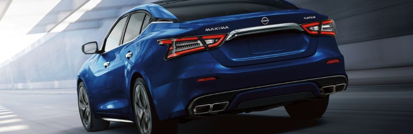 One blue color 2022 Nissan Maxima is running on the road.