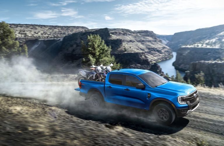 2025 Ford Ranger in blue driving by a canyon