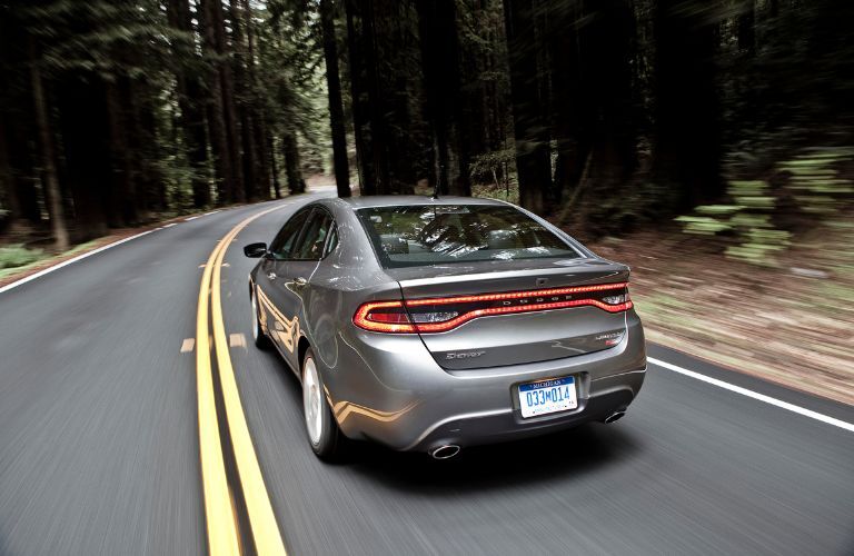Rear three-quarter view of the 2016 Dodge Dart driving on road