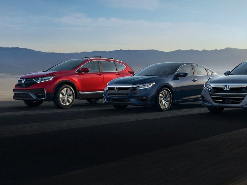 A variety of cars driving along the road in formation