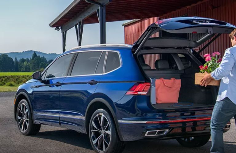 Man loading the cargo space of the 2024 Volkswagen Tiguan