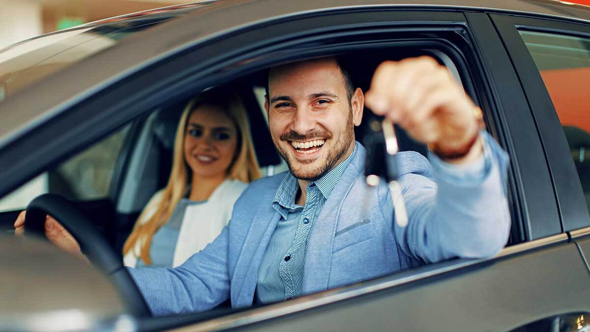 Person sitting inside car showing his keys