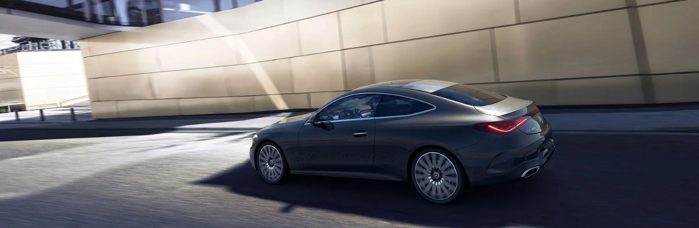 side view image of the 2025 Mercedes-Benz CLE 300 4MATIC® Coupe on a road