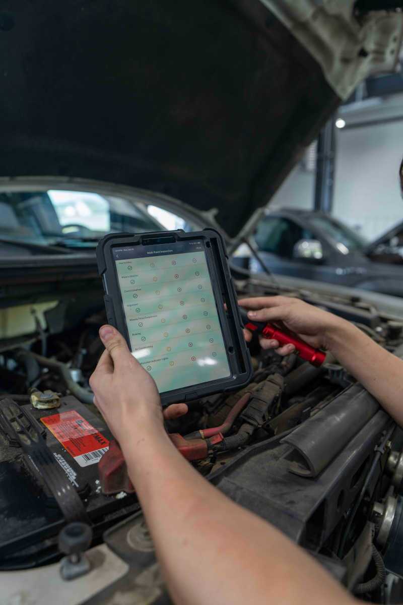 A Wild Willies technician running a diagnostic on a vehicle