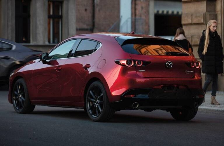 Rear driver angle of a red 2020 Mazda3 hatchback
