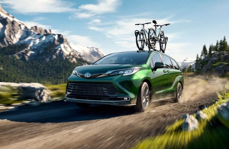 Front view of a Toyota Sienna carrying bicycles