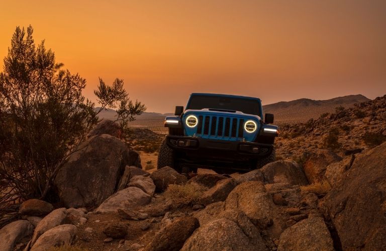 front grille view of the 2022 Jeep Wrangler on rocks