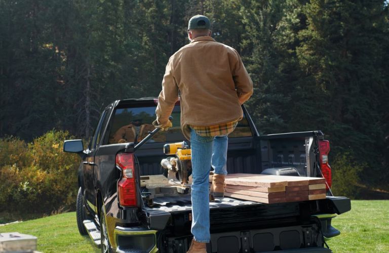 2025 Chevrolet Silverado 1500 bed with a person climbing in