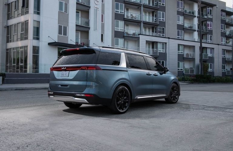 The rear exterior of a blue 2022 Kia Carnival.