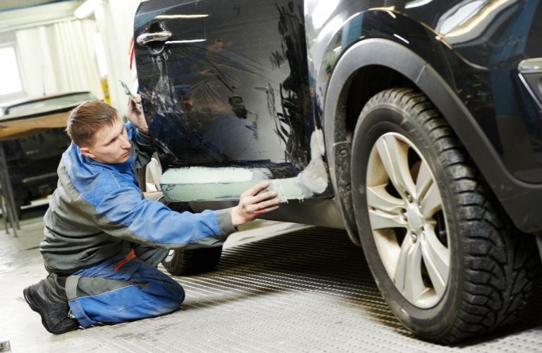 A service person working on a car