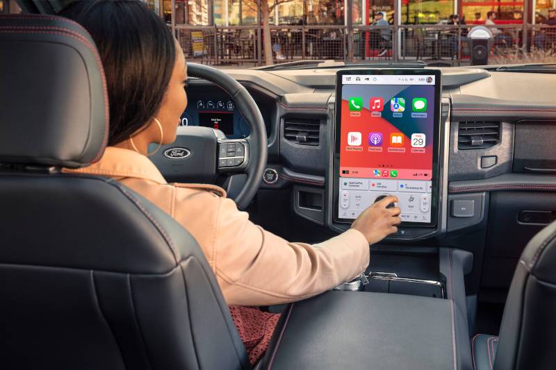 A woman using the massive infotainment system in the 2024 Ford Expedition Platinum.