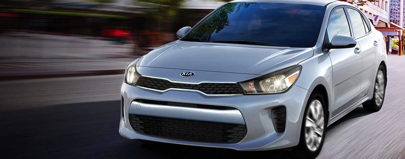 Silver 2020 Kia Rio driving on a city highway
