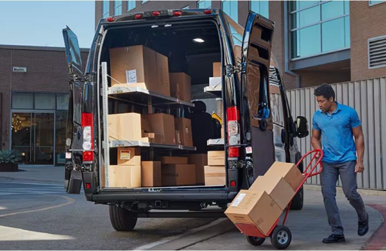 a worker loading the cargo space of a Ram ProMaster Cargo Van