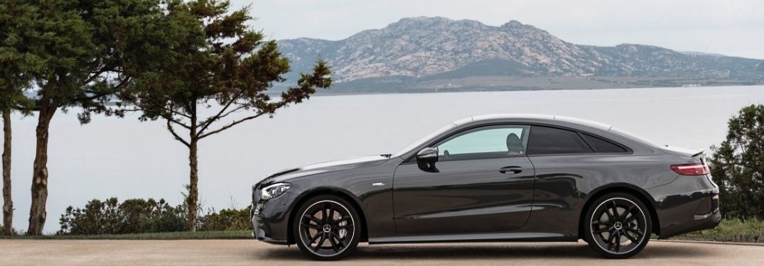 2021 MB E-Class exterior driver side profile in front of lake and mountain